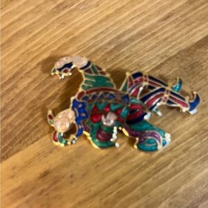 Jester brooch marked fish and crown